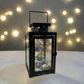 Decorative lantern with a cartoon character inside, surrounded by blurred lights in the background.