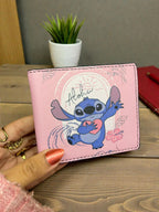 Pink wallet with cartoon character on a wooden surface